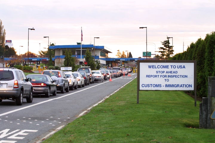 Vehicles line up to enter the United States at a border crossing between Blaine, Washington and White Rock, British Columbia