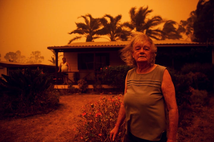 Nancy Allen and Brian Allen stand outside the house as high winds push smoke and ash from the Currowan Fire toward Nowra, New South Wales, Australia, on Saturday.