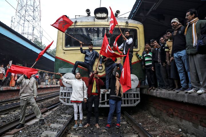 Supporters of the Communist Party of India-Marxist (CPI-M) block a passenger train during an anti-government protest rally, organised as part of a nationwide strike by various trade unions in Kolkata, India, January 8, 2020. REUTERS/Rupak De Chowdhuri