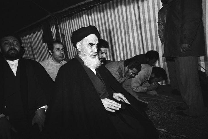 Ayatolla Ruholla Khomeini leads daily prayers at his small villa near Paris before his return to Iran.