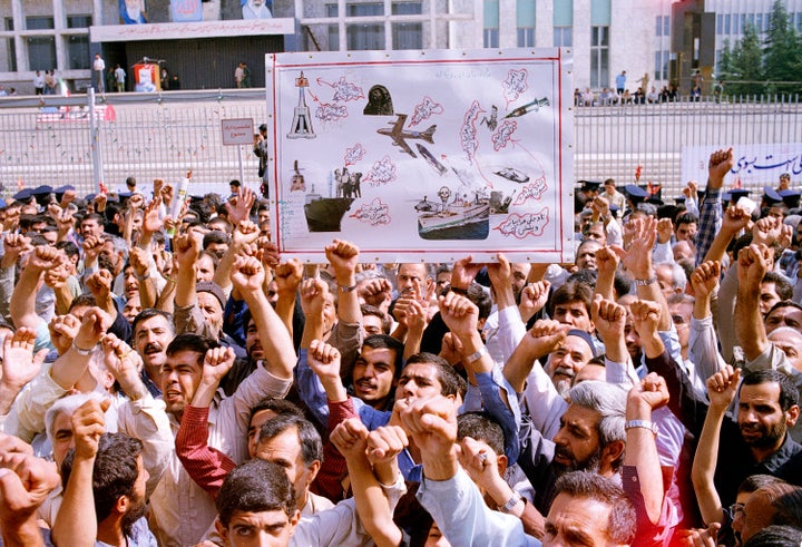 Thousands of Iranians chanting "Death to America" participate in a mass funeral for 76 people killed when the USS Vincennes shot down Iran Air Flight 655, in Tehran, Iran, July 7, 1988.