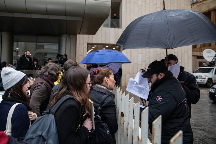 BEIRUT, LEBANON - JANUARY 08: Security guards check a list of press members allowed access to the former chairman of Nissan and Mitsubishi Motors Carlos Ghosn's press conference on January 08, 2020 in Beirut, Lebanon. The former chairman of Nissan was awaiting trial in Japan on charges of financial crimes when he fled house arrest in Tokyo, arriving in Beirut on December 30. (Photo by Chris McGrath/Getty Images)