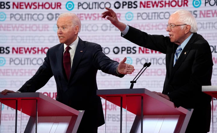 Former Vice President Joe Biden and Vermont Sen. Bernie Sanders speak toward the end of the sixth 2020 U.S. Democratic debate, Dec. 19, 2019.