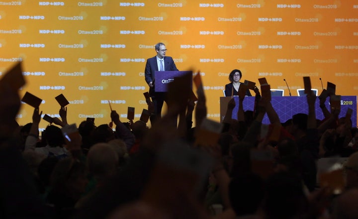 NDP delegates show hands as they vote on resolutions in Ottawa on Feb. 16, 2018.