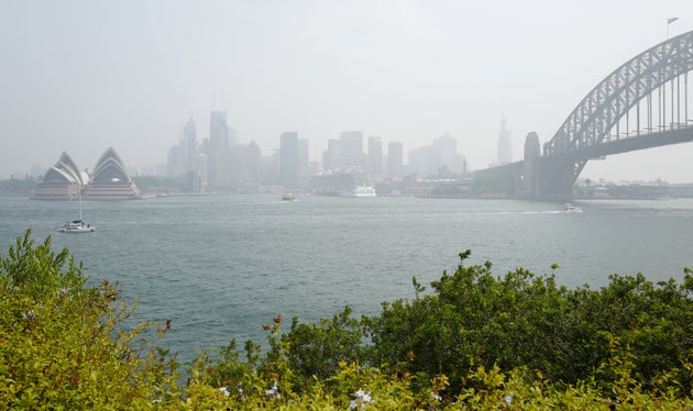 The Harbour Bridge and Opera House surrounded by smoke on January 08, 2020.