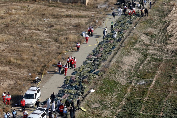 Bodies of the victims of a Ukrainian plane crash are collected by rescue team at the scene of the crash in Shahedshahr, southwest of the capital Tehran, Iran.