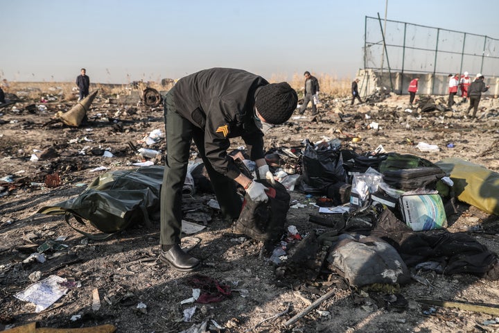 Rescuers search the debris at the crash site.