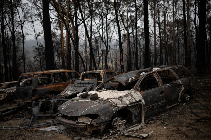 Destroyed cars are seen next to burnt bushland in the village of Mogo, Australia on Jan. 8, 2020.