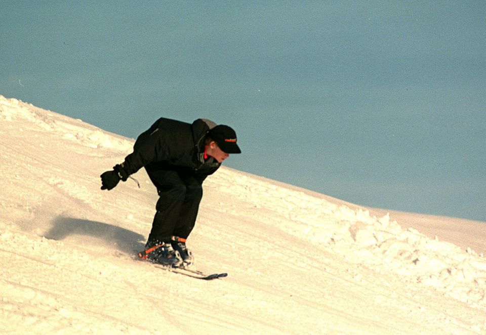 Prince Harry lands after he successfully completing a jump from a snow hill in the Swiss Alps in 1999. 