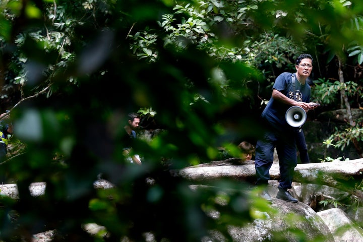 A members of a rescue team plays a recording of Nora's mother's voice during the search for the missing teenager 