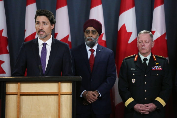 Prime Minister Justin Trudeau, left, speaks as Minister of National Defence Harjit Sajjan, centre, and Chief of Defence Staff Gen. Jonathan Vance, right, listen during a news conference Jan. 9, 2020 in Ottawa.