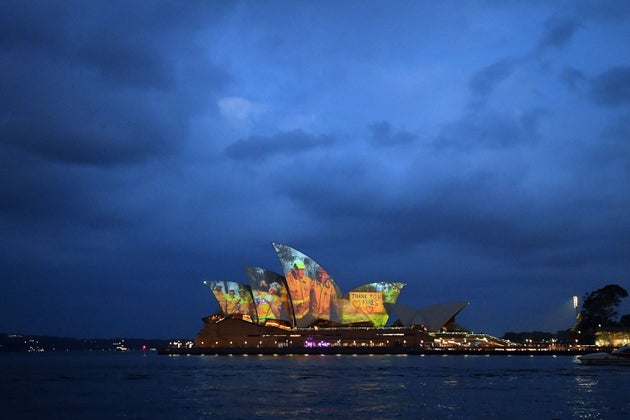 The sails of the Opera House are lit with a series of images to show support for the communities affected by the bushfires and to express the gratitude to the emergency services and volunteers in Sydney on January 11, 2020. - Massive bushfires in southeastern Australia have a