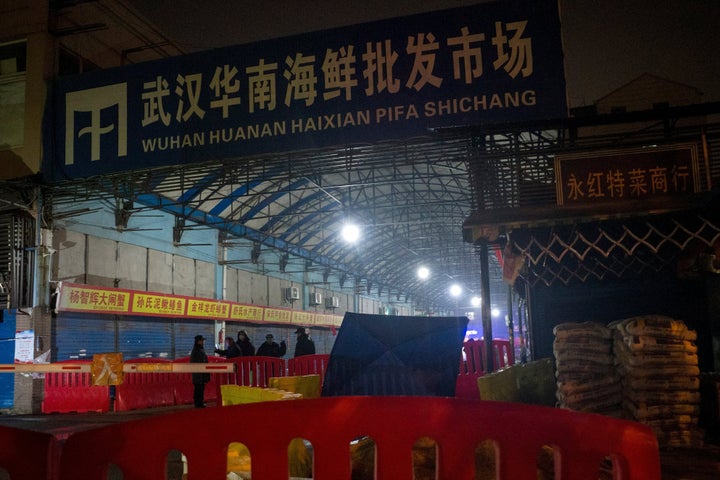 Security guards stand in front of the closed Huanan Seafood Wholesale Market in the city of Wuhan, in the Hubei Province of China, on Jan. 11, 2020, where the Wuhan health commission said that the man who died from a respiratory illness had purchased goods.