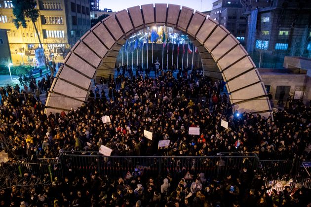 People gather for a candlelight vigil to remember the victims of the Ukraine plane crash, at the gate of Amri Kabir University in Tehran where some of the victims of the crash were former students.