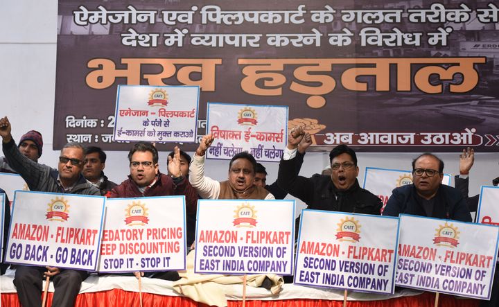 Traders hold placards and raise slogans during a sit in hunger strike against unfair business practices of Amazon and Flipkart, at Jantar Mantar, on December 27, 2019 in New Delhi.