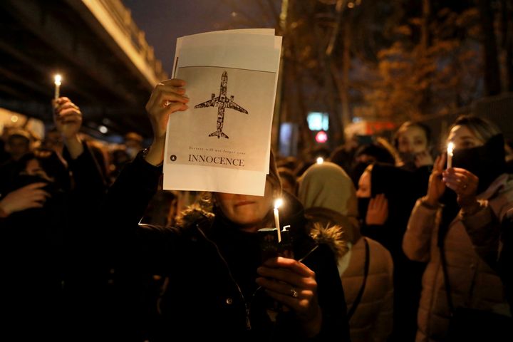 People gather for a candlelight vigil to remember the victims of the Ukraine plane crash, at the gate of Amri Kabir Universit