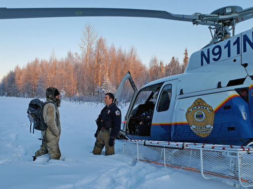 Tyson Steele is greeted by Alaska State Trooper's tactical flight officer Zac Johnson after more than 20 days in the wilderness.