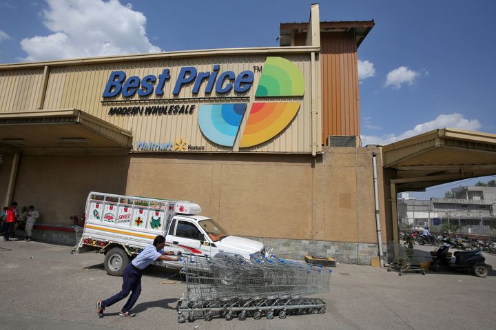 A man pushes shopping trolleys at a Walmart India's Best Price Modern Wholesale store in Jammu May 8, 2018. 