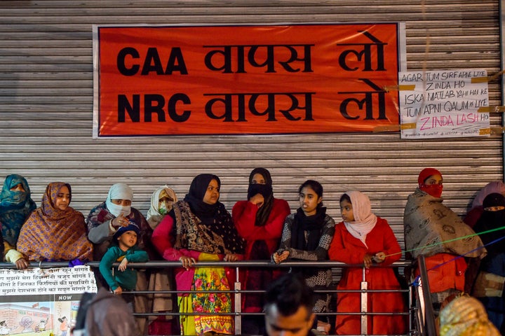 Protesters stand in front of a banner during a demonstration at Shaheen Bagh area. The photo was taken on 7 January, 2020.