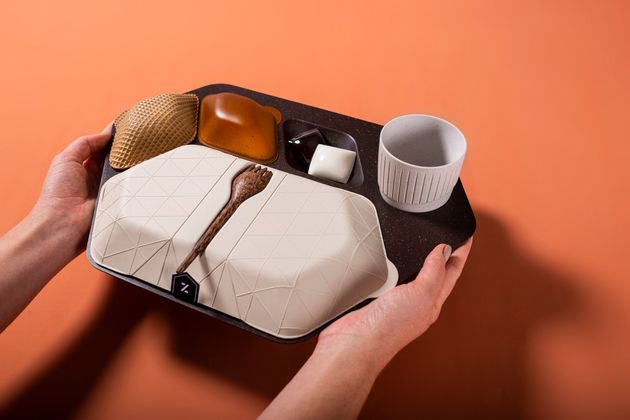 The economy meal tray designed by PriestmanGoode is made from materials including coffee grounds and husks, wheat bran, banana leaf and coconut wood. 