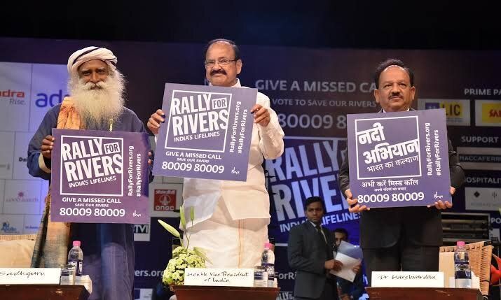 Vice President Venkaiah Naidu and Isha Foundation’s Jaggi Vasudev placard with ‘missed call campaign’ of the Rally for Rivers in New Delhi. Environmentalists have questioned the rationale behind the Cauvery Calling project, while others smell a rat.