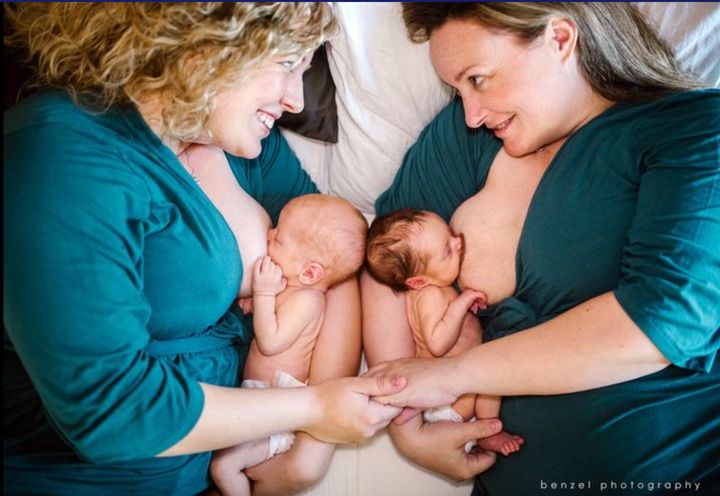 Jaclyn and Kelly Pfeiffer breastfeed their newborn twins in this powerful image by Melissa Benzel.