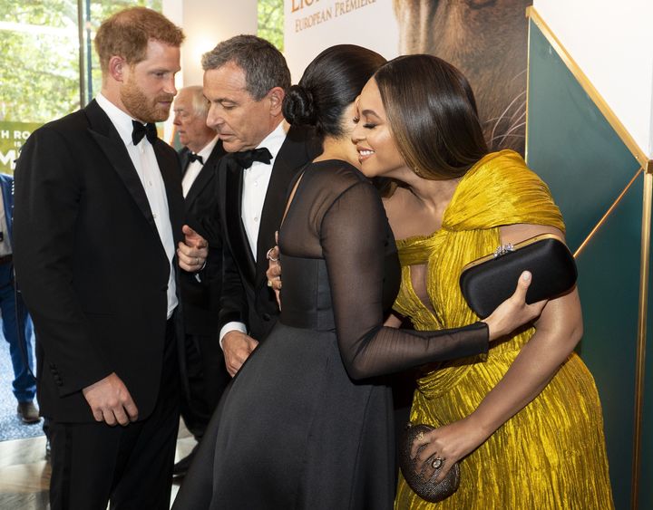 Harry chats with Disney CEO Robert Iger as Meghan embraces Beyoncé as they attend the European premiere of the "The Lion King" in London on July 14, 2019.