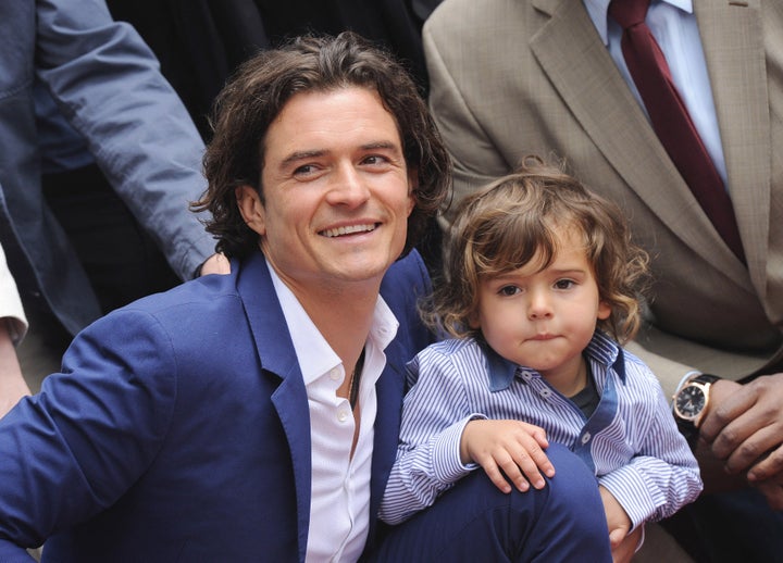 Orlando Bloom and his son, Flynn, attend the ceremony in honor of his new star on the Hollywood Walk of Fame on April 2, 2014.