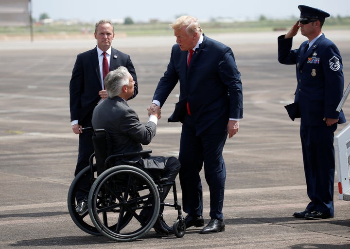 Gov. Greg Abbott, seen here greeting President Donald Trump in May 2018, appears to share Trump's concerns about refugees.