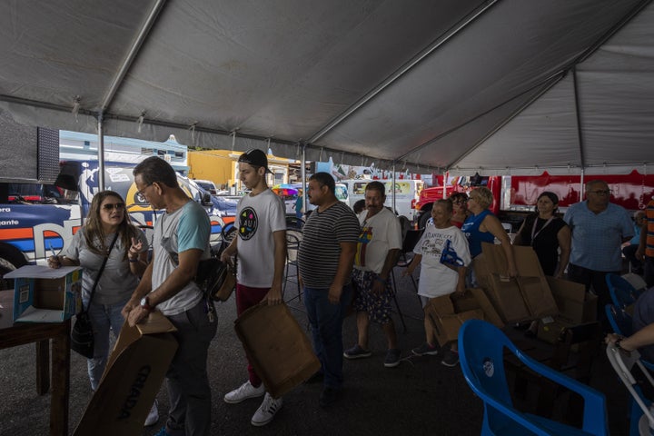 People line up to receive supplies after a 6.4-magnitude earthquake hit Guayanilla, Puerto Rico, on Jan. 11, 2020.