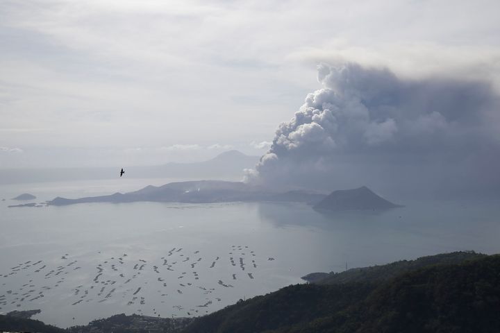 Taal volcano continues to spew ash on Monday Jan. 13, 2020, in Tagaytay, Cavite province, south of Manila, Philippines. Red-hot lava gushed out of the Philippine volcano Monday after a sudden eruption of ash and steam that forced villagers to flee en masse and shut down Manila’s international airport, offices and schools.