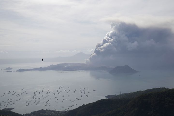 Taal volcano continues to spew ash on Monday Jan. 13, 2020, in Tagaytay, Cavite province, south of Manila, Philippines. Red-h