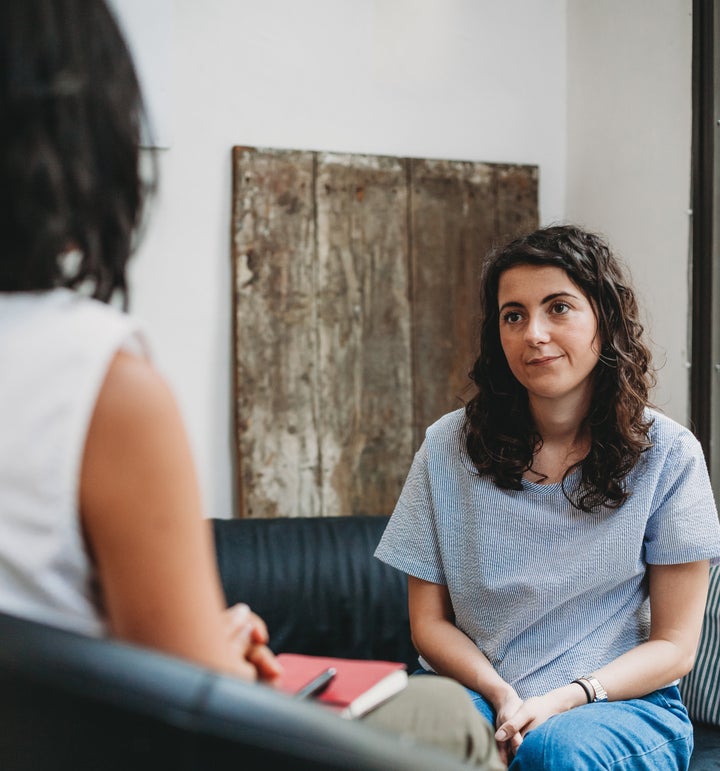 Psychotherapy session, woman talking to his psychologist in the studio
