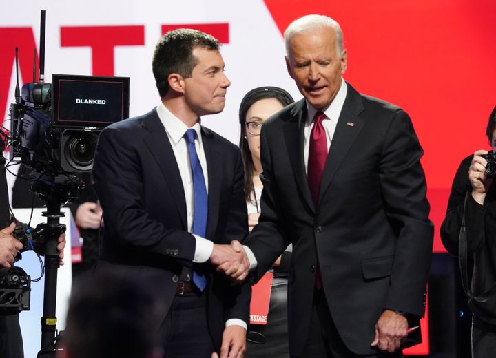 Former South Bend, Indiana, Mayor Pete Buttigieg, left, shakes hands with former Vice President Joe Biden after the Democratic presidential debate in October. Left-wing activists see both men as an obstacle to electing a progressive president.