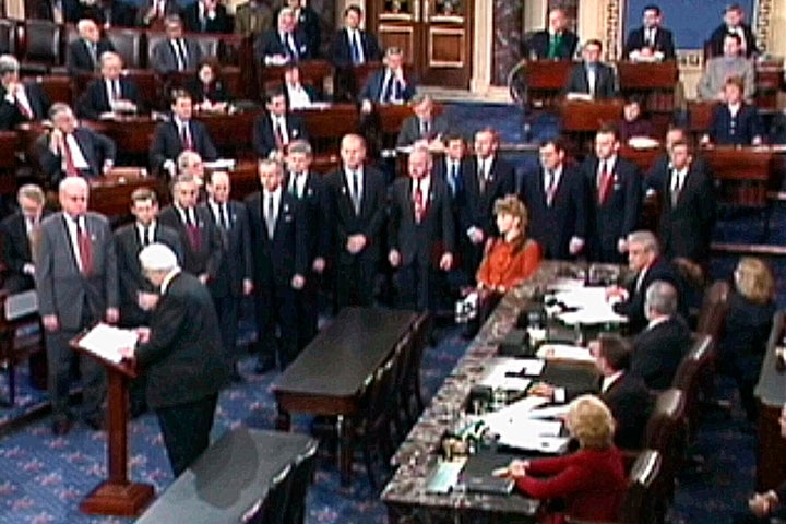 In January 1999, then-House Judiciary Committee Chairman Rep. Henry Hyde, R-Ill., reads the articles of impeachment against President Bill Clinton to the Senate as the other House managers who will conduct the impeachment trial watch in Washington.