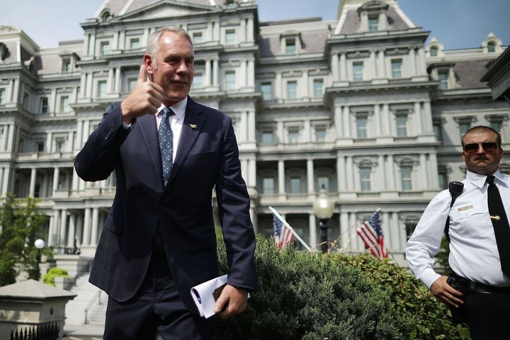 Interior Secretary Ryan Zinke talks to journalists outside the White House in August 2018.