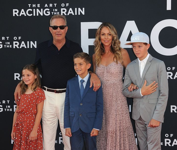 Kevin Costner and wife Christine Baumgartner with their three children -- (left to right) Grace, Hayes and Cayden -- at the premiere of the film "The Art Of Racing In The Rain" at a theater in Los Angeles last August.