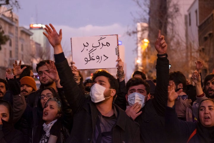 A protester holds a sign that reads, Death To The Liar, during a vigil for the victims of the Ukraine Boeing 737 plane crash in Tehran on Jan. 11, 2020.