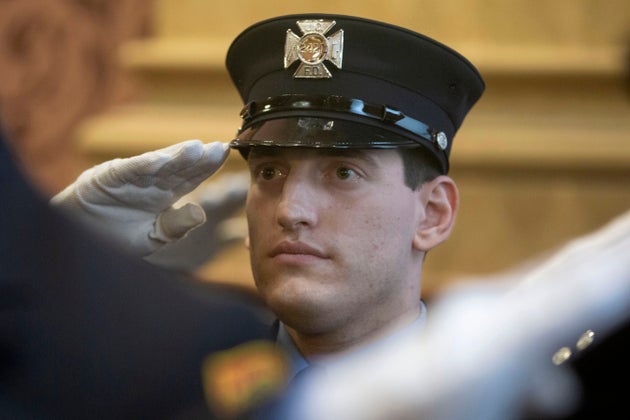 Photographs released by the Jersey City Mayor’s Office show Sam Springsteen saluting during his swearing-in.