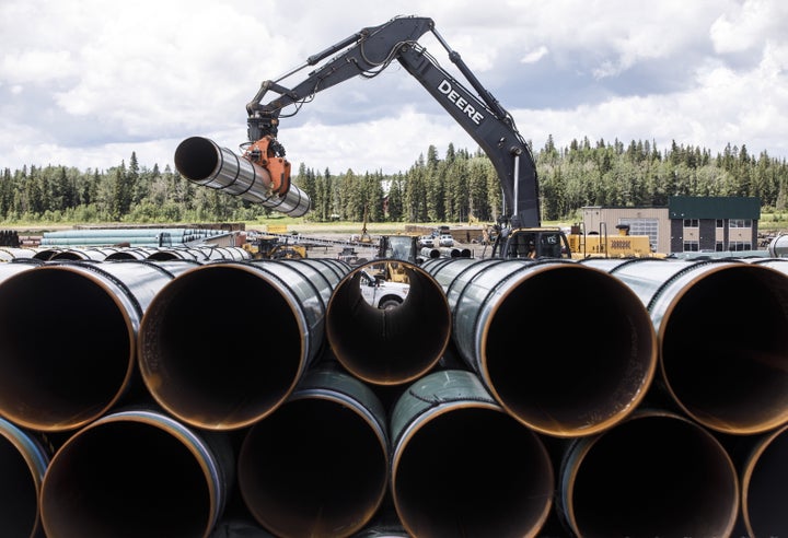 Pipe for the Trans Mountain pipeline expansion are unloaded in Edson, Alta. on June 18, 2019.