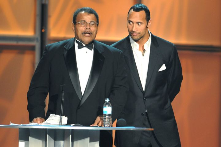 Actor Dwayne "The Rock" Johnson, right, with his father, Rocky Johnson, at the WWE Hall of Fame induction in 2008 in Orlando, Florida.