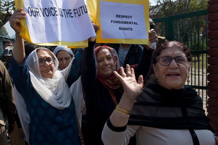 A small group of women under the banner of ‘Women of Kashmir’, hold placards during a peaceful protest in Srinagar, Kashmir, Oct. 15, 2019. 