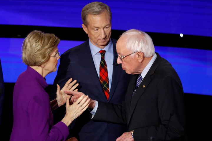 Elizabeth Warren and Bernie Sanders exchange words after a Democratic presidential primary as fellow candidate businessman Tom Steyer looks on.