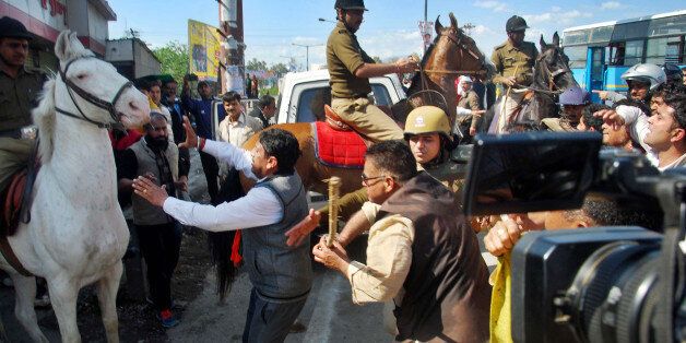 DEHRADUN, INDIA - MARCH 14: MLA Ganesh Joshi beating a horse during a BJP rally at Vidhansabha, on March 14, 2016 in Dehradun, India. (Photo by Vinay Santosh Kumar/Hindustan Times via Getty Images)