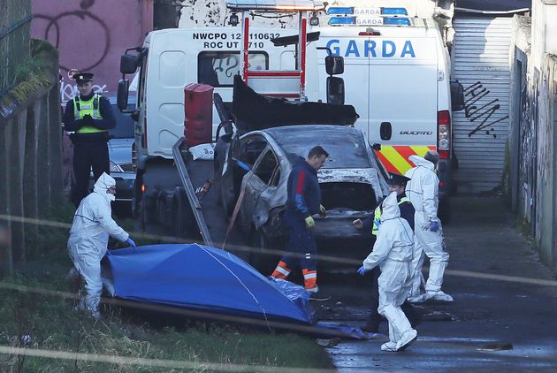 A burnt out car which contained partial human remains is removed from the scene on Trinity Terrace in the Drumcondra area of Dublin