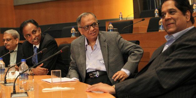 Indian founding member of Infosys, N.R. Narayana Murthy (2R), looks at outgoing chairman K.V. Kamath (R), as CEO SD Shibulal (2L) and former CEO Kris Gopalakrishna (L) look on at a press conference at the company's headquarter in Bangalore.