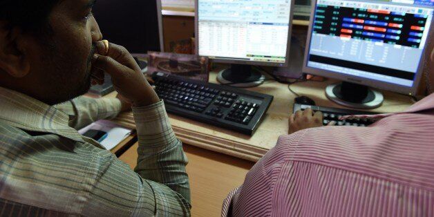 A stock dealer watches share prices on his screen at a brokerage house in Mumbai.