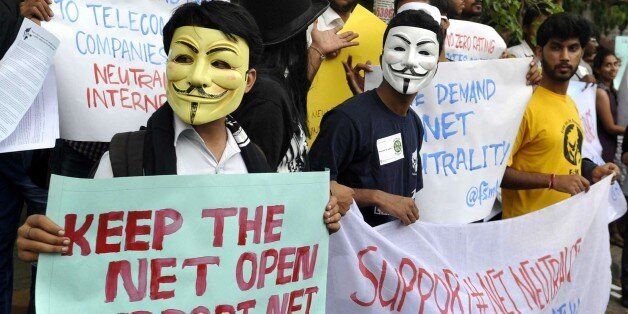 Indian activists wear Guy Fawkes masks as they hold placards during a demonstration supporting 'net neutrality' in Bangalore on April 23, 2015. The activists urged the Indian government to pass legislation to ensure net neutraliy and prevent private service providers from gaining control over the internet.