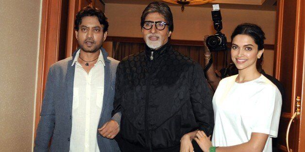 Indian Bollywood actors Irrfan Khan, (L), Amitabh Bachchan (C) and Deepika Padukone pose during the promotion of comedy-drama Hindi film 'Piku' directed by Shoojit Sircar in Mumbai on May 2, 2015. AFP PHOTO (Photo credit should read STR/AFP/Getty Images)