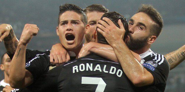 Real Madrid's Portuguese forward Cristiano Ronaldo (back) celebrates with teammates after scoring during the UEFA Champions League semi-final first leg football match Juventus vs Real Madrid on May 5, 2015 at the Juventus stadium in Turin. AFP PHOTO / MARCO BERTORELLO (Photo credit should read MARCO BERTORELLO/AFP/Getty Images)